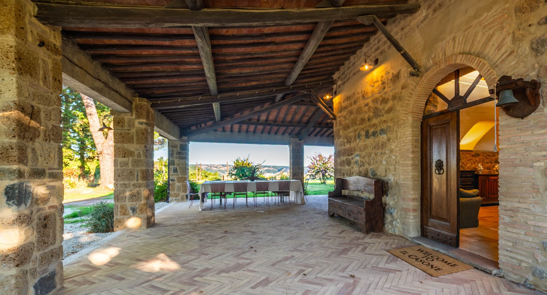 The covered portico with its long table and the wooden front door